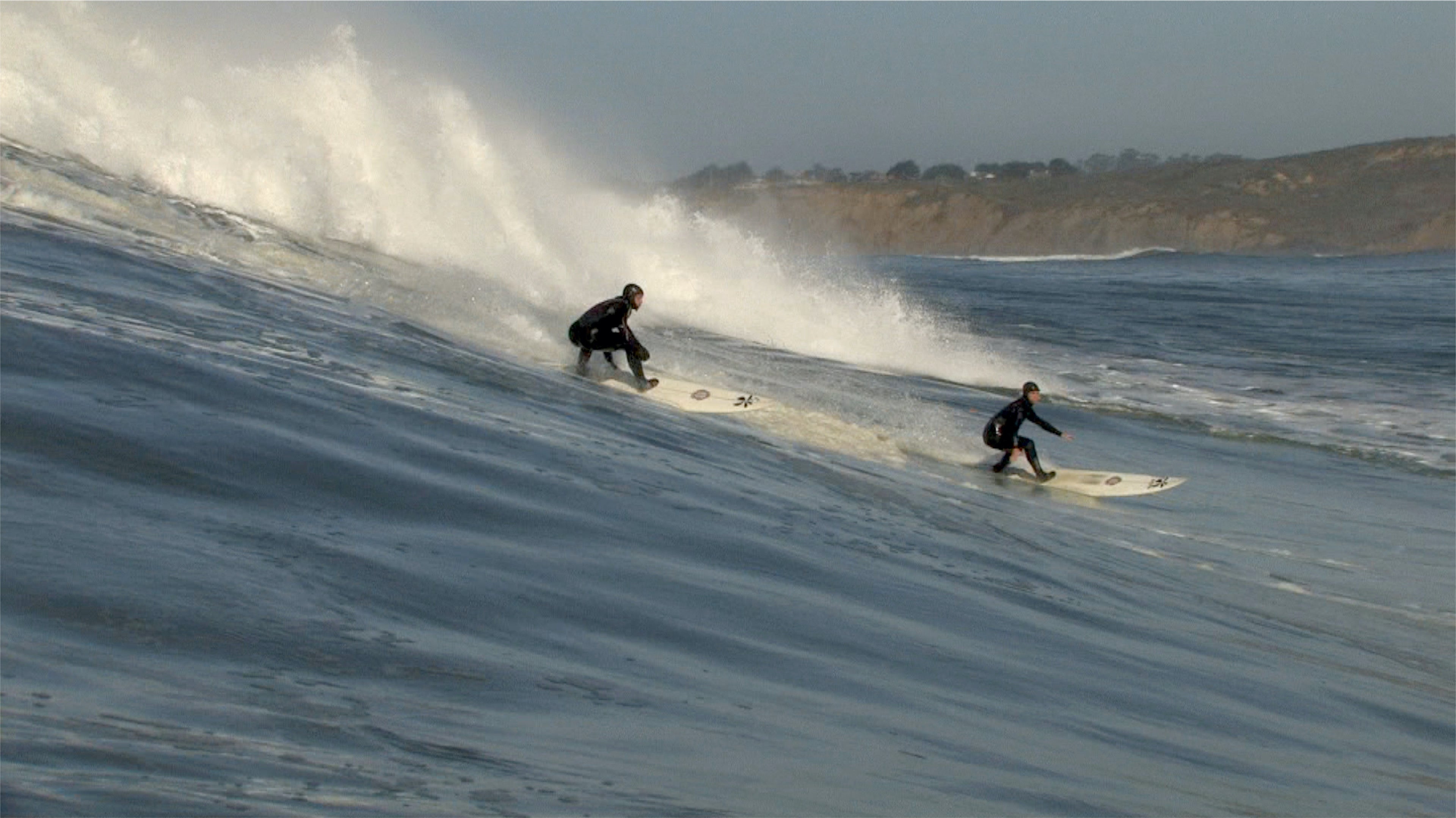 Artist Dusty Stefanick surfing Mavericks with friend Tim West